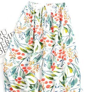 LONGER LENGTH CASUAL PANTS O/S WHITE BACKGROUND W/ORANGE FLOWERS & GREEN LEAVES